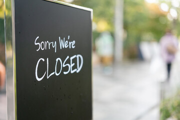 Sorry, we are closed display banner for the restaurant or coffee shop in English text. Sign and...