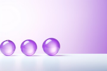  a group of three glass balls sitting on top of a white table next to a purple and white wall with a light reflection on the bottom half of the glass.