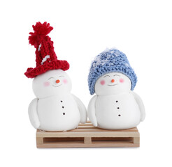 Cute decorative snowmen in color hats isolated on white