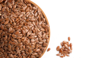 Flax seeds in a wooden plate, copy space.