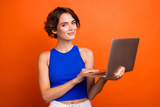 Photo of adorable cute girl dressed blue top working apple samsung modern gadget isolated orange color background