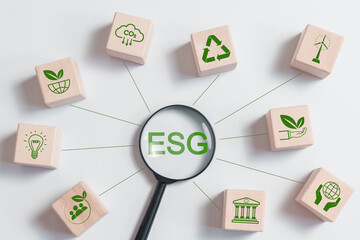 ESG environmental, social and governance. Magnifying glass focus to ESG text and ESG icons network...