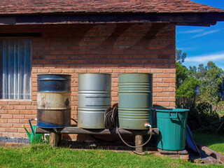 Obraz premium A home made rain water collector system made from steel barrels, in a farm near the colonial town of Villa de Leyva in central Colombia.