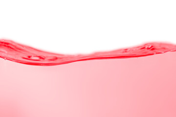 Red water surface with splashes and bubbles on white background.