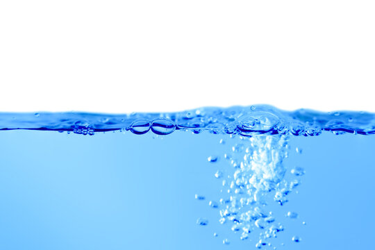 Blue water surface with splashes and bubbles on white background.