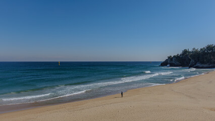 Fototapeta na wymiar Beach scene with high waves on a windy day