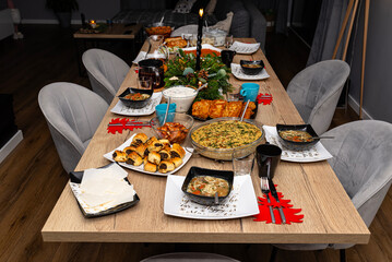A table set before Christmas dinner with many traditional Polish dishes.