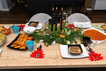 A table set before Christmas dinner with many traditional Polish dishes.