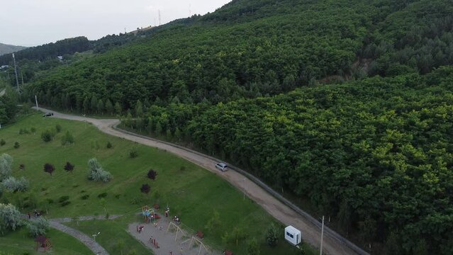 Drone footage of a small mountain city Moinesti, Bacau, Romania, with large forest