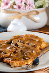 Sauerkraut pancakes /fuczka/ with mushroom sauce .