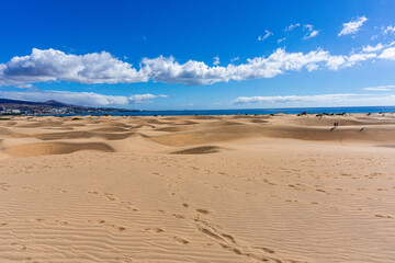 Fototapeta na wymiar Gran Canaria Maspalomas. Shot from the Dunes with Sand and Sun and the Beach.
