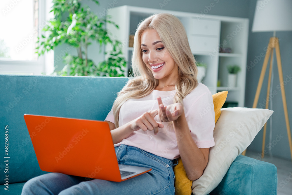 Poster photo of charming adorable cheerful girl sitting comfort apartment sofa counting numbers fingers dis