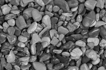 Black sea pebbles background texture. dark aquarium soil. beach pebbles close up