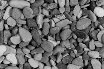 Black sea pebbles background texture. dark aquarium soil. beach pebbles close up
