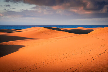 Fototapeta na wymiar Sunrise over the Atlantic Ocean. Shot from the Dunes of Maspalomas Gran Canaria