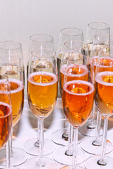 Filled glasses of champagne in orange and yellow