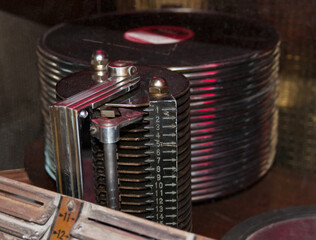 old jukebox with stack of records