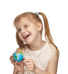 Blonde baby 6 years old, in a white dress shows a globe