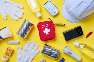 Disaster preparedness kit on yellow background.
