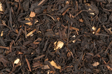 Pile leaf tea with various additives background, top view. Heap of dried tea texture