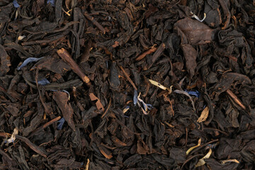 Pile leaf tea with various additives background, top view. Heap of dried tea texture
