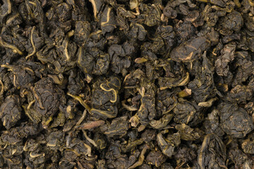 Pile leaf tea with various additives background, top view. Heap of dried tea texture