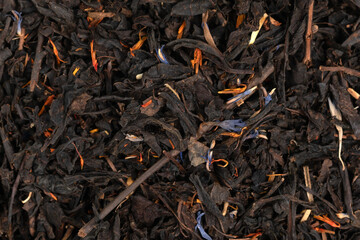 Pile leaf tea with various additives background, top view. Heap of dried tea texture