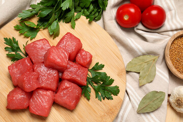 Raw beef meat and different ingredients for cooking delicious goulash on table, flat lay
