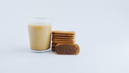Biscuits filled with chocolate cream and coffee with milk isolated on a white background.