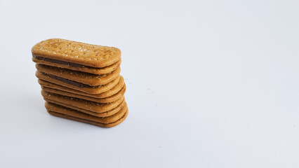 Stacked chocolate filled biscuits. Sweet cake isolated on white background.

