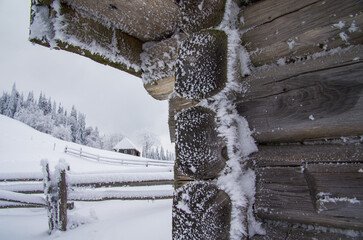 Hoarfrost on the walls of a wooden hut.