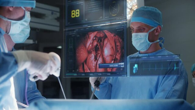 Surgeons operate patient in modern hospital operating room. Doctors perform heart surgery using 3D graphics virtual hologram showing vital signs. VFX animation. Innovative AI technologies in medicine.