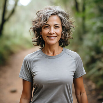 Smiling mature woman enjoying a serene nature walk depicting happiness vitality and a healthy lifestyle