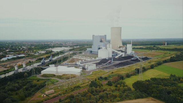 Aerial view of power station in the countryside with a high chimney in Europe.