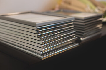 Pile of certificates in golden and silver frames, reward certificate and diploma for employees and colleagues, company contest award, winning a prize in corporate competition