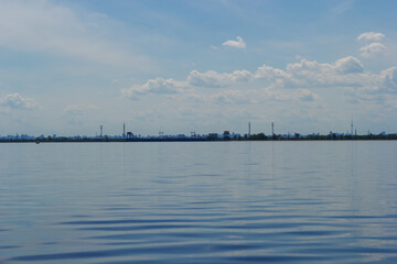 Panoramic view of Kyiv from the lake. City silhouette on the horizon line. Water surface of a lake...
