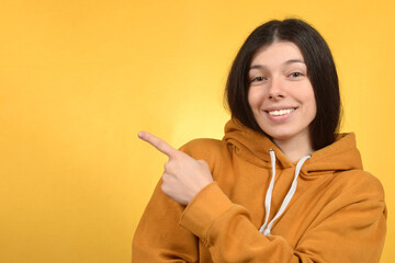 portrait of a cute woman on a yellow background - obrazy, fototapety, plakaty
