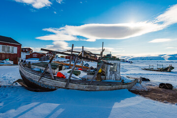 Shipwrecked Vessel Amidst the Snowy Coast of Greenland