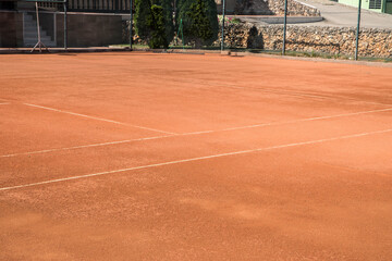 Red clay court surface closeup in tennis complex