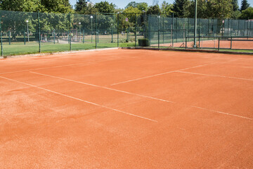 Red clay court surface closeup in tennis complex