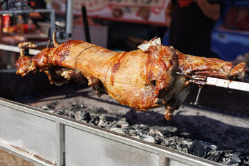 Roast lamb carcass on a spit. Grilled meat
