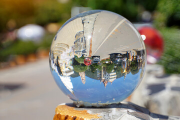 Upside-down realistic pictures of people Buildings and cars travel on the road in clear, spherical crystal balls decorated on the walls, which act like convex lenses. Soft and selective focus.