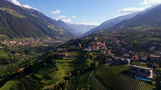 Tourism of northern Italy. Traditional picturesque mountain village Schenna (Scena) near Merano town in Trentino - Alto Adige region. view of medieval castle, aerial  panoramic drone view
