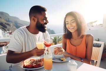 Happy african young couple eating and drinking in Santorini
