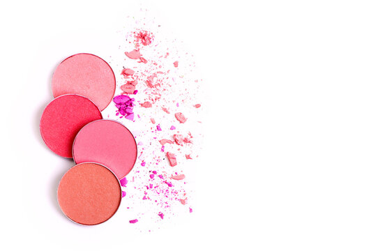 Pink Blusher and Face Powder. Shimmering bright palette of Face Cosmetics Make up. Craked texture of round blusher against white background with copy space for text.