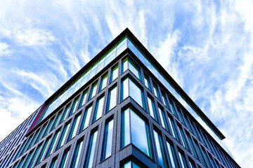 Fototapeta na wymiar Angular Perspective: Modern Building and Blue Sky