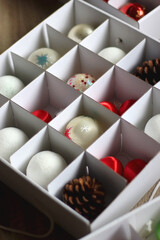 Boxes with various organized Christmas ornaments. Decorating or taking down the Christmas tree. Selective focus.