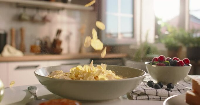 Unknown person pours cereal into plate. Advertising cinematic slow motion no people. Leisurely cozy morning, essence of lifestyle, food, and domestic life. Pleasant family traditions. Comfort concept
