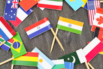 Fototapeta na wymiar The concept is diplomacy. In the middle among the various flags are two flags - India, Paraguay
