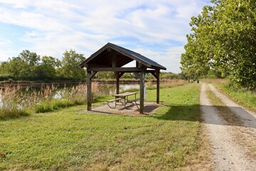 The wood shelter in the park on a sunny day.